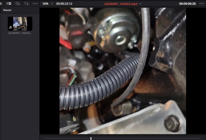 my knock sensor hiding behind the coil pack bracket - screen shot from phone video.jpg