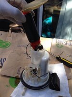 Evo fuel pump grommet and the stock white spacer that goes under it, shown here on an Aeromoti...jpg