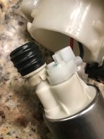 Evo fuel pump grommet on a Walbro 450, the stock spacer under it had to be drilled out to fit...jpeg